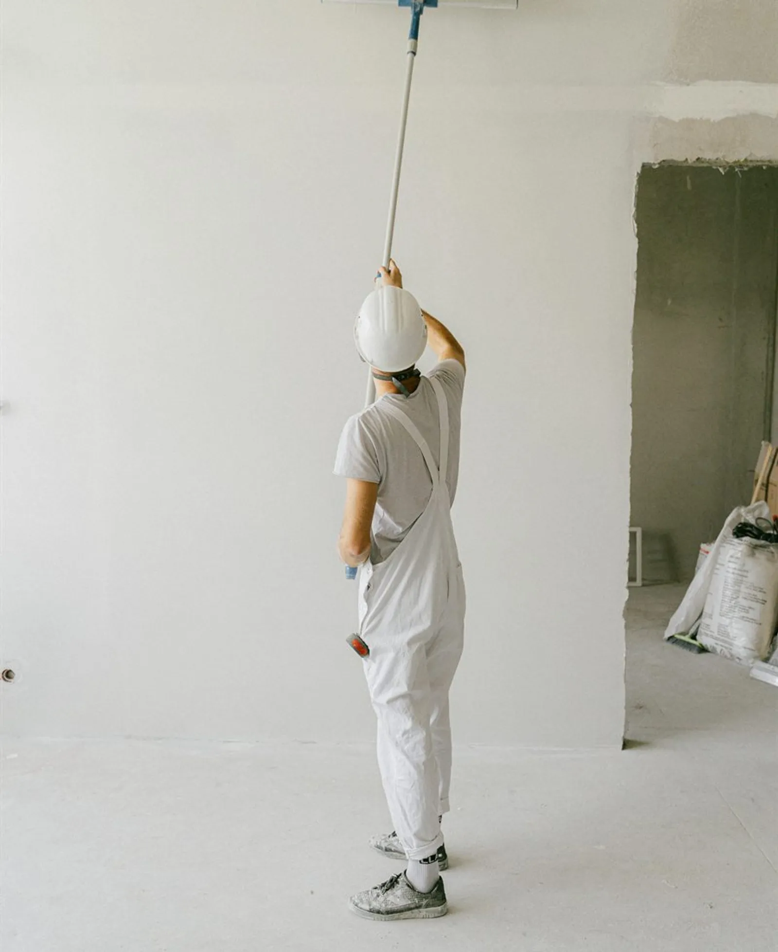 Paint roller applying paint to an interior wall
