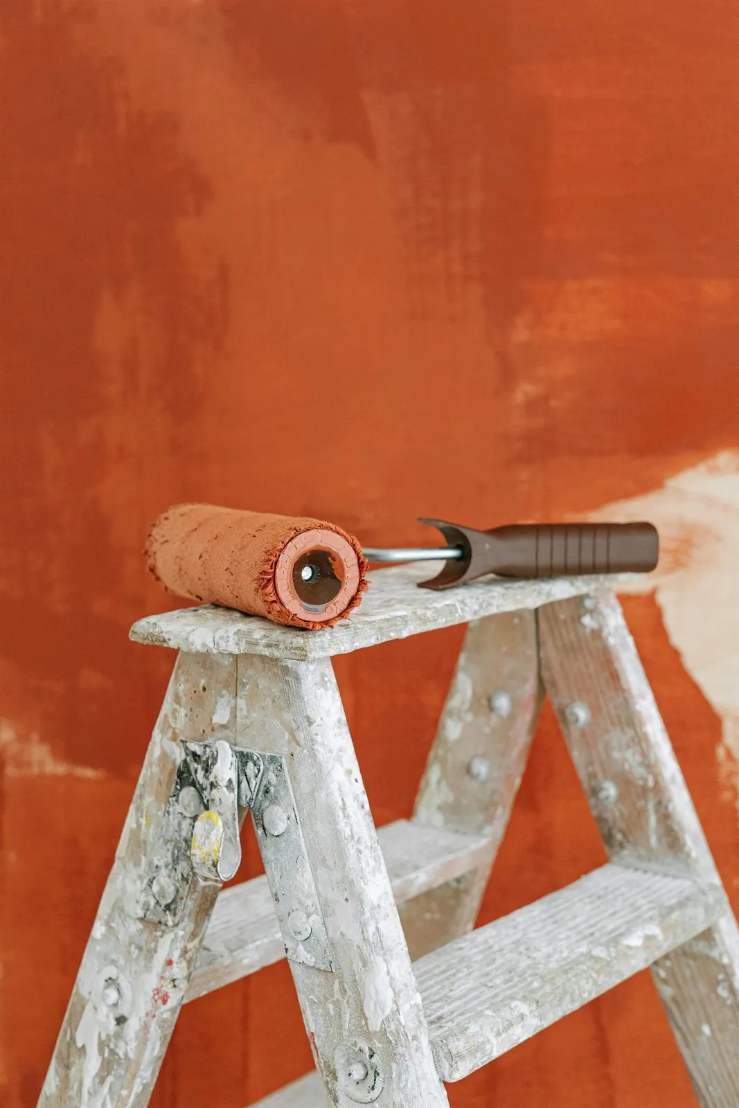 Paint roller on a step ladder during an interior painting project