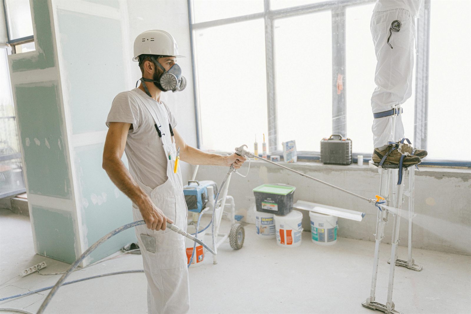 Interior room prepared for painting with covered floors and clean wall lines